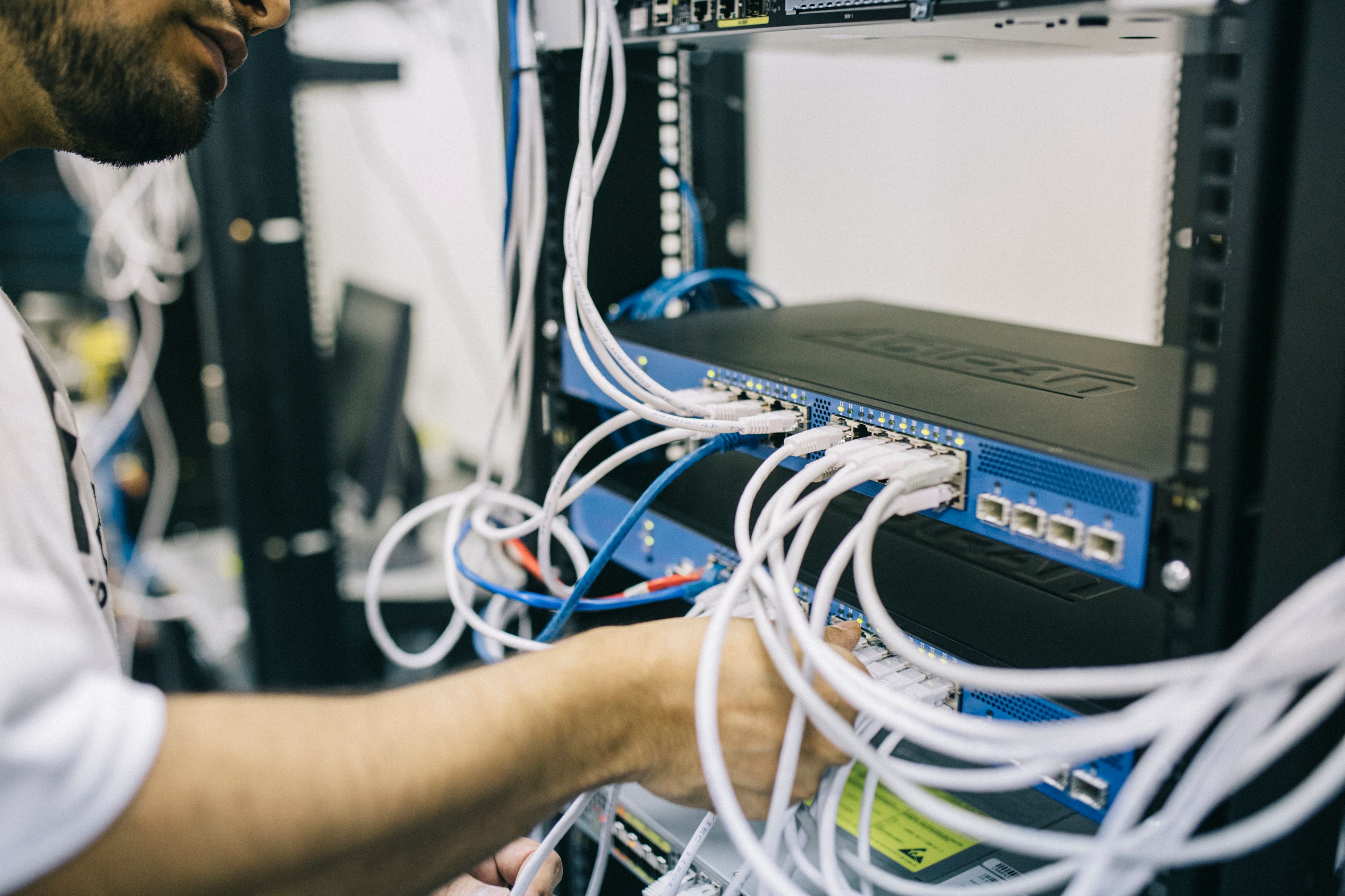 IT technician working with a network server rack